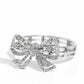 Paparazzi Accessories - It's All A-Bow-t Me - White Bracelets&nbsp;Infused along elastic stretchy bands, airy silver frames gleam along the wrist for a monochromatic display. Encrusted in white rhinestones, an oversized, airy silver bow glitters at the center of the design for a touch of class and refinement.  Sold as one individual bracelet.