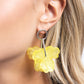 Paparazzi Accessories - Glassy Garden - Yellow Earring a high-sheen silver hoop gives way to acrylic Primrose and Lemon flowers that are threaded through the center of a hoop by a silver attachment for a whimsical, fun pop of color along the ear. Earring attaches to a standard post fitting. Sold as one pair of post earrings.