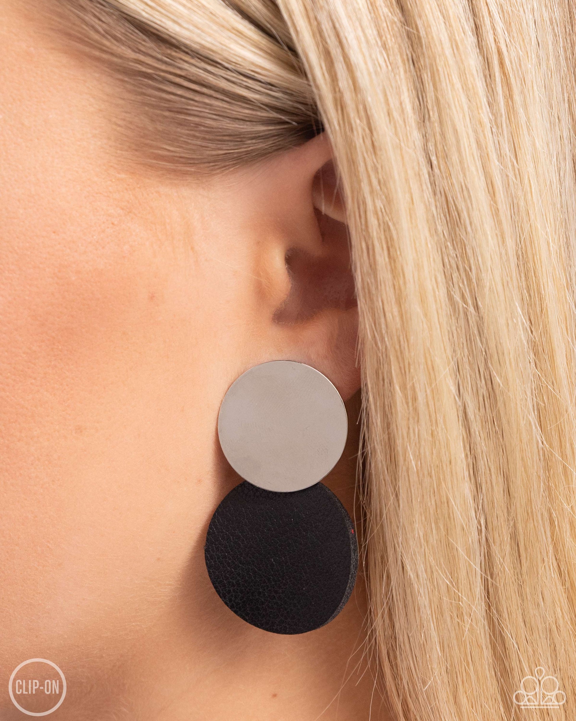 Paparazzi Accessories - Leather Leader - Black Clip-On Earrings an&nbsp;oversized silver disc gives way to an even larger disc of black leather for a badlands basic. Earring attaches to a standard clip-on fitting.  Sold as one pair of clip-on earrings.