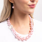 <p>Paparazzi Accessories - Crystal Class - Pink Pearl Necklaces infused along an invisible string, a collection of oversized glossy baby pink pearls and silver rings that are interspersed throughout the design loop around the neckline. A crystal-like, multi-faceted bead and dainty double-stranded pearls attach to one side of the design for additional interest and appeal. Features an adjustable clasp closure.</p> <p><i>Sold as one individual necklace. Includes one pair of matching earrings.</i></p>