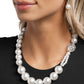 <p data-mce-fragment="1">Infused along an invisible string, a collection of oversized glossy white pearls and silver rings that are interspersed throughout the design loop around the neckline. A crystal-like, multi-faceted bead and dainty double-stranded pearls attach to one side of the design for additional interest and appeal. Features an adjustable clasp closure.</p> <p data-mce-fragment="1"><i data-mce-fragment="1">Sold as one individual necklace. Includes one pair of matching earrings.</i></p>