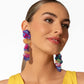Featuring an iridescent hue, a collection of purple, pink, and orange sequins cascade from a collection of purple sequins that flourish from a hot pink seed beaded starfish for a coastal, chic look. Earring attaches to a standard post fitting. Due to its prismatic palette, color may vary.  Sold as one pair of post earrings.