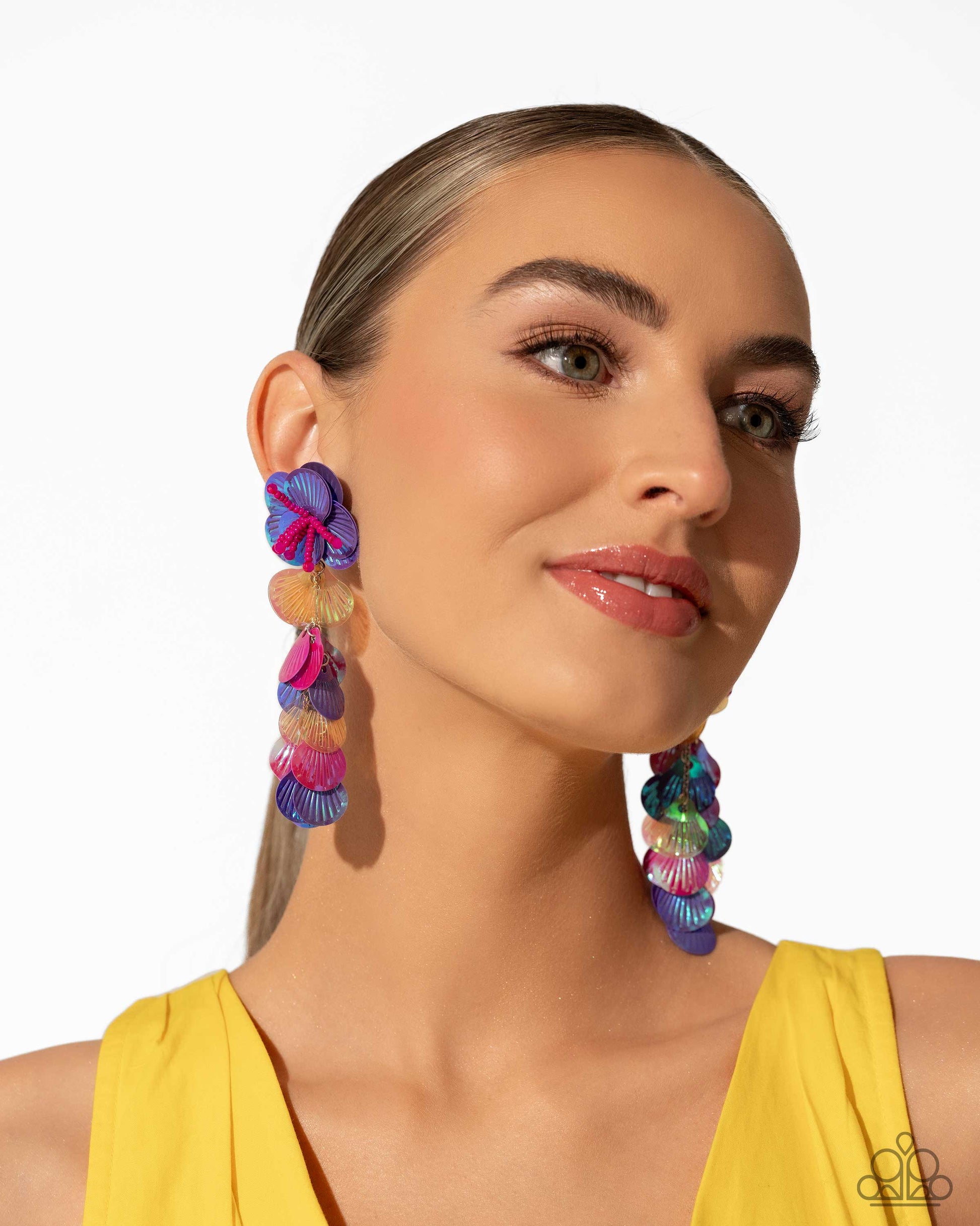 Featuring an iridescent hue, a collection of purple, pink, and orange sequins cascade from a collection of purple sequins that flourish from a hot pink seed beaded starfish for a coastal, chic look. Earring attaches to a standard post fitting. Due to its prismatic palette, color may vary.  Sold as one pair of post earrings.