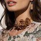 Light brown satin petals form into a decadent trio of rosettes atop a sleek satin ribbon in the same hue along the collar for a whimsical display. Features an adjustable clasp closure.  Sold as one individual choker necklace. Includes one pair of matching earrings.