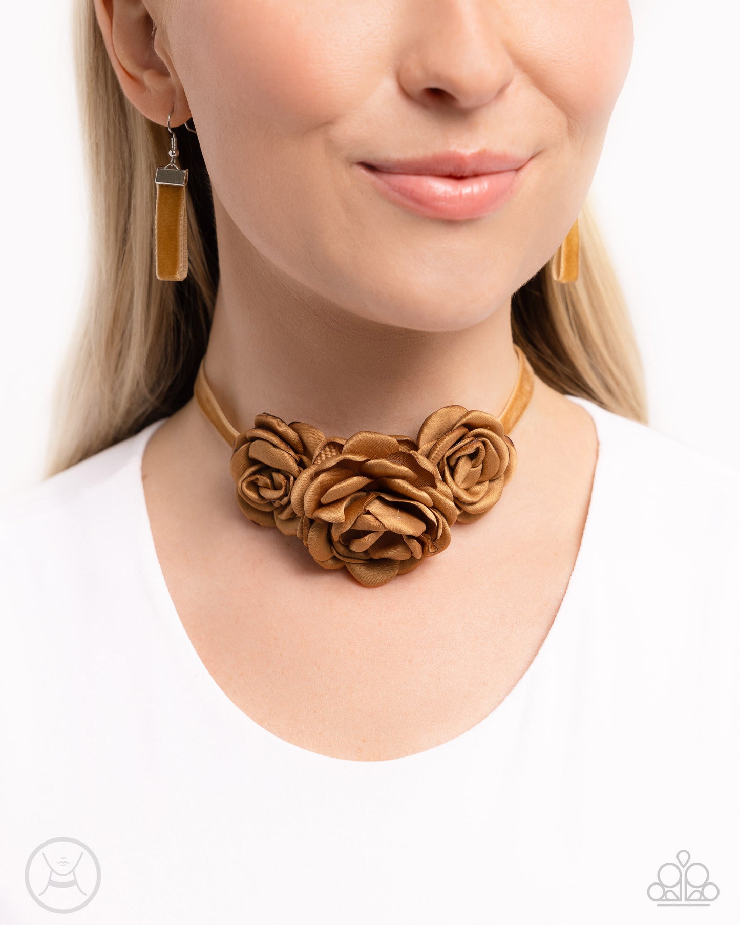 Light brown satin petals form into a decadent trio of rosettes atop a sleek satin ribbon in the same hue along the collar for a whimsical display. Features an adjustable clasp closure.  Sold as one individual choker necklace. Includes one pair of matching earrings.