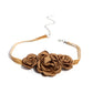 Light brown satin petals form into a decadent trio of rosettes atop a sleek satin ribbon in the same hue along the collar for a whimsical display. Features an adjustable clasp closure.  Sold as one individual choker necklace. Includes one pair of matching earrings.