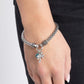 Featuring a high-sheen finish, a rounded silver mesh claw chain streams along the wrist from silver studded caps on a stretchy band. The meshed strand attaches to a silver ring at the center of the wrist where a white rhinestone-encrusted palm tree and solitaire blue zircon gem pressed in a silver fitting swing for a whimsical finish.  Sold as one individual bracelet.