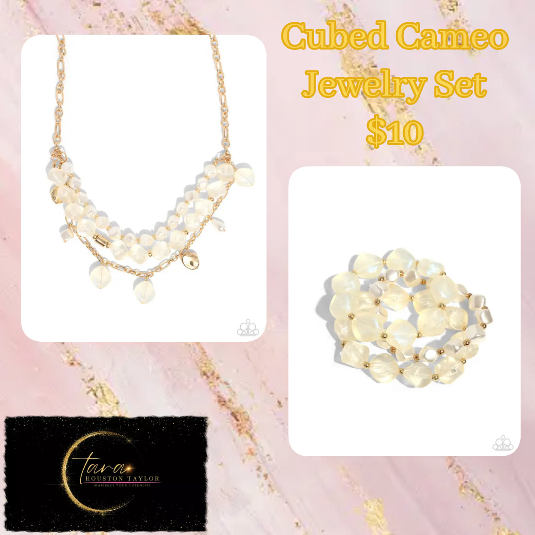 Paparazzi Accessories - Cubed Cameo - Gold Jewelry Set Cubed white pearls join a strand of clear acrylics that alternate with gold discs and a gold fitting around the neckline. A third strand joins the refined display featuring a gold abstract chain that has dangling gold beads, white pearls in a variety of shapes, and glittery clear acrylics for a classy display. Features an adjustable clasp closure. Sold as one individual necklace. Includes one pair of matching earrings.