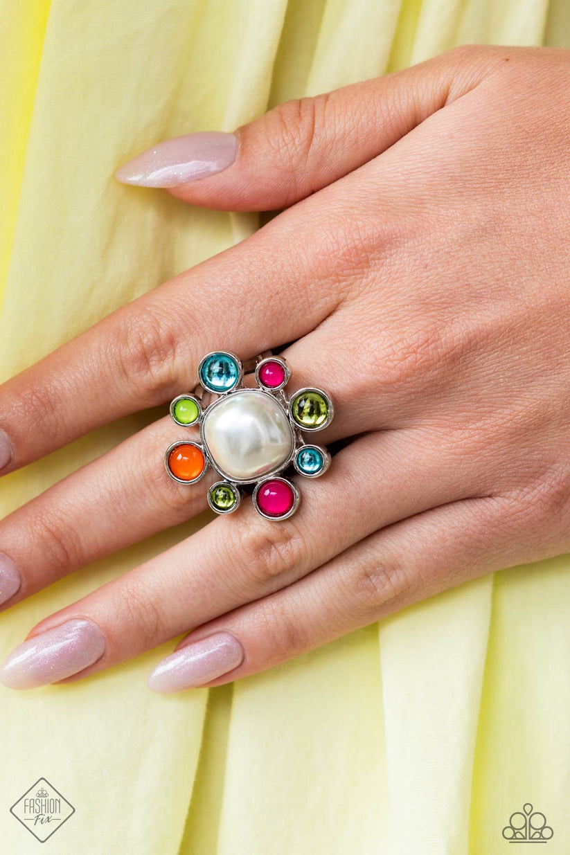 Pressed into a high-sheen silver frame, glassy and milky olive, Pink Peacock, turquoise, orange, and Kohlrabi petals encircle an abstract pearly center, creating an ethereal flower centerpiece atop the finger. Features a stretchy band for a flexible fit.  Sold as one individual ring.