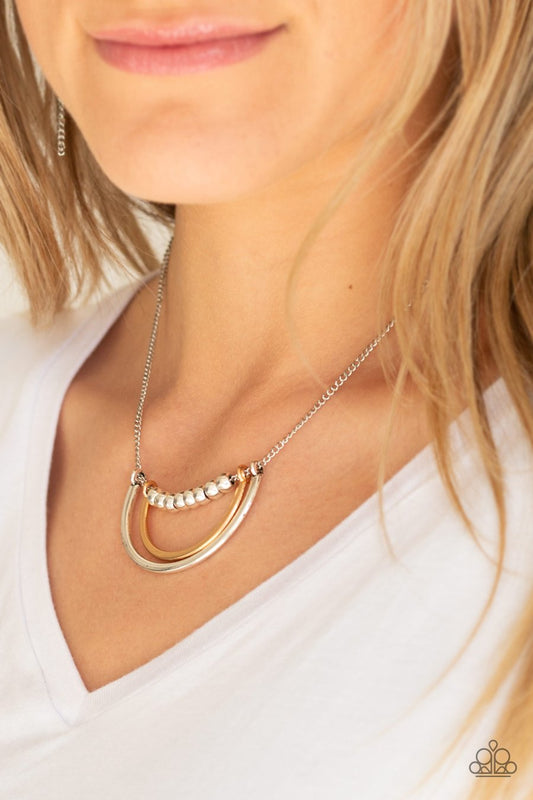 Paparazzi Accessories Artificial Arches - Silver Necklaces a strand of shiny silver beads give way to bowing gold and silver frames, creating an edgy pendant below the collar. Features an adjustable clasp closure.  Sold as one individual necklace. Includes one pair of matching earrings.
