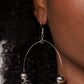 Paparazzi Accessories - I Can Take a Compliment - Silver Earrings a stunning array of studded silver accents, oversized silver beads, and hematite rhinestone encrusted black beads are threaded along a dainty silver wire hoop, resulting in a dazzling pop of color. Earring attaches to a standard fishhook fitting.  Sold as one pair of earrings.