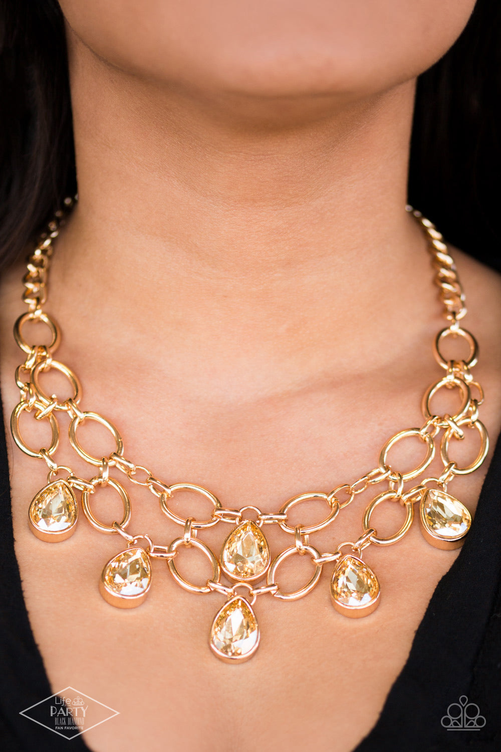 Show-Stopping Shimmer - Gold Link Necklaces joined by dainty gold links, two rows of dramatic gold chain layer below the collar in a fierce fashion. Golden teardrops drip from the glistening layers, adding a timeless shimmer to the show-stopping piece. Features an adjustable clasp closure.  Sold as one individual necklace. Includes one pair of matching earrings.
