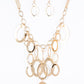Paparazzi Accessories A Golden Spell - Gold Blockbuster Necklaces large gold links and shimmering textured gold rings cascade below a gold chain freely, allowing for movement that makes a bold statement. Features an adjustable clasp closure.