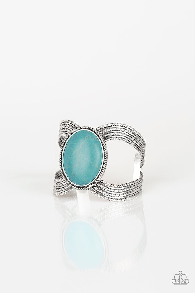 Coyote Couture - Blue Cuff Bracelet a dramatic turquoise stone pendant is pressed into the center of textured silver bars, creating a bold seasonal cuff. Sold as one individual bracelet.