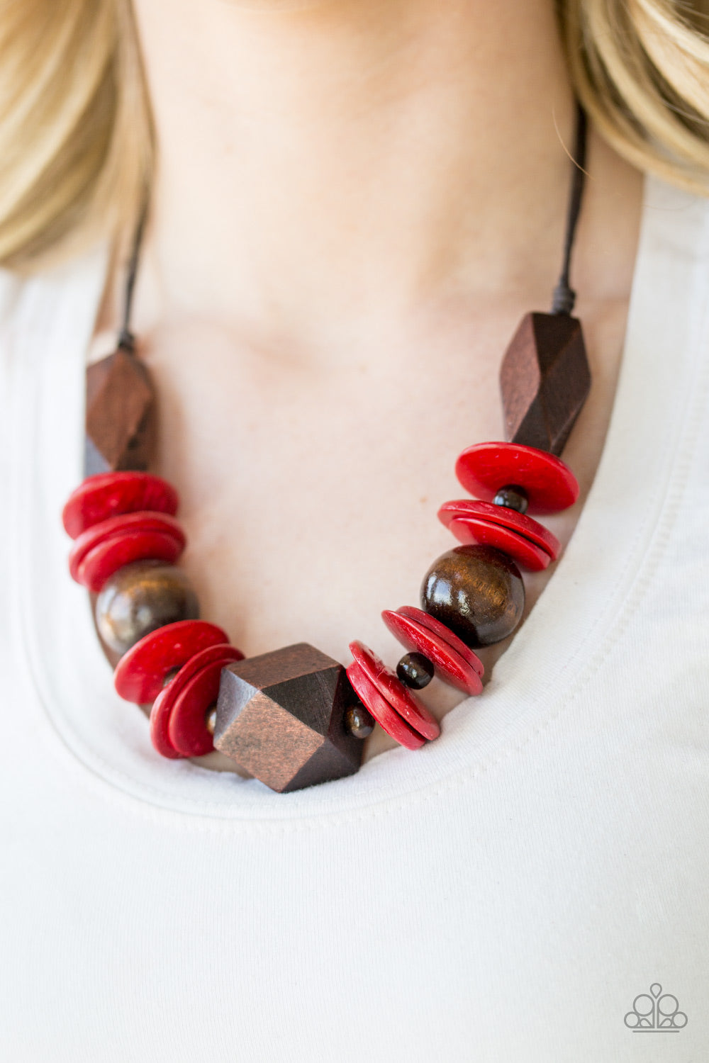Paparazzi Accessories Pacific Paradise - Red Wood Necklaces featuring abstract geometric finishes, mismatched brown wooden beads and fiery red accents are threaded along shiny brown cording. A dramatic geometric bead adorns the center, creating a bold summery look below the collar. Features a button loop closure.  Sold as one individual necklace. Includes one pair of matching earrings.