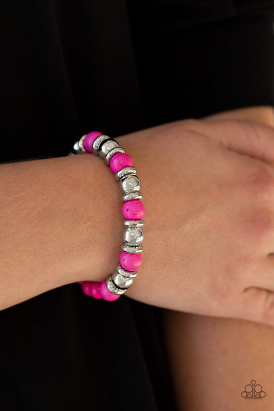 Paparazzi Accessories Across the Mesa - Pink Bracelets a collection of silver accents and vivacious pink stones are threaded along a stretchy band for a seasonal look.  Sold as one individual bracelets.