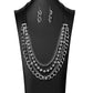 The Arlingto 2020 Zi Collection Necklaces attached to two strips of black leather, strands of bedazzled white rhinestone encrusted silver beads drape between an exaggerated display of mismatched silver and gunmetal chains down the chest. With its edgy sparkle, grunge meets glamour in this heart-stopping statement-maker. Features an adjustable clasp closure. Sold as one individual necklace. Includes one pair of matching earrings.