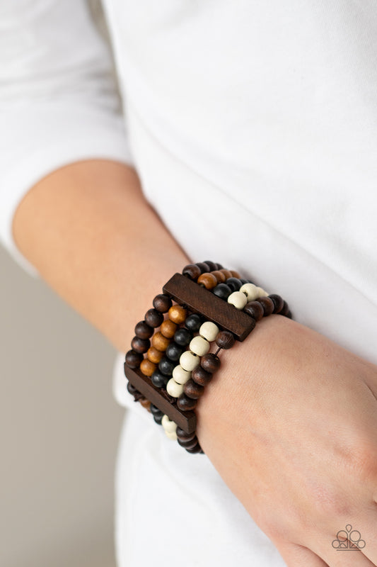 Paparazzi Accessories Caribbean Catwalk - Multi Wood Bracelets held in place by rectangular wooden frames, strands of brown, black, and white wooden beads are threaded along stretchy bands around the wrist for a colorfully tropical look.