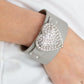 Flauntable Flirt - Silver Bracelets encrusted in blinding white rhinestones, an oversized silver heart frame is studded in place across the front of a gray leather band, creating a flirtatious centerpiece around the wrist. Features an adjustable snap closure.  Sold as one individual bracelet.  Paparazzi Jewelry is lead and nickel free so it's perfect for sensitive skin too!