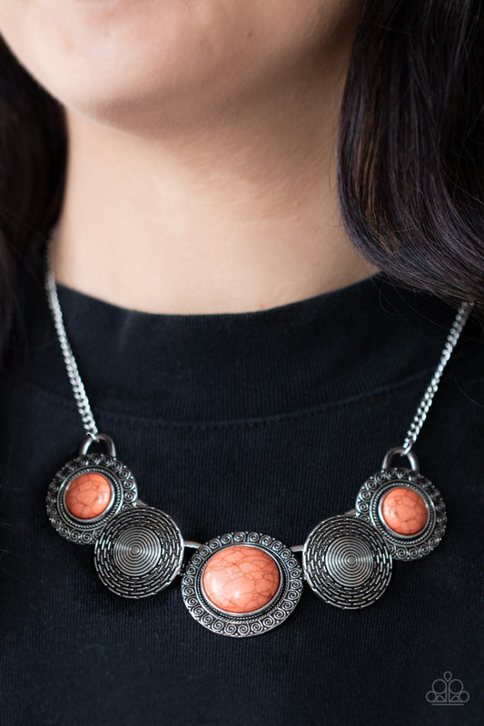 Canyon Cottage - Orange Stone Necklaces embossed in swirly patterns, orange stone frames link with antiqued silver frames radiating with spiral textures below the collar for a seasonal inspired flair. Features an adjustable clasp closure.  Sold as one individual necklace. Includes one pair of matching earrings.  Paparazzi Jewelry is lead and nickel free so it's perfect for sensitive skin too!