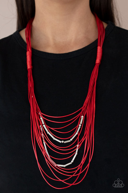 Paparazzi Accessories - Nice CORD-ination - Red Necklaces two rows of dainty silver beads and cylindrical rods are threaded along strands of shiny red cording that has been knotted in place, creating edgy rows across the chest. Features a magnetic closure.  Sold as one individual necklace. Includes one pair of matching earrings.