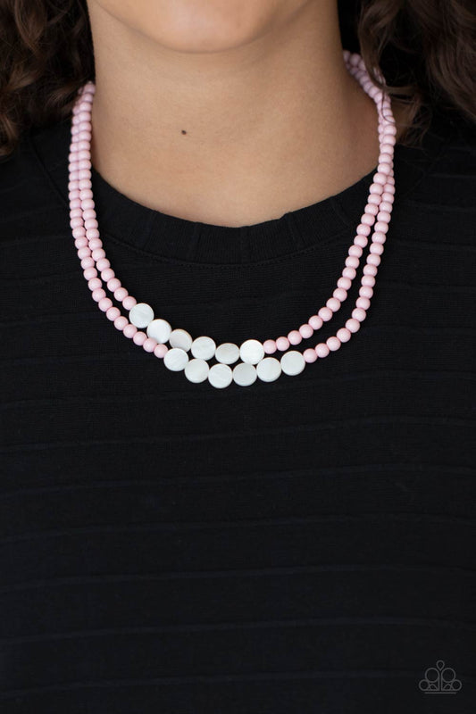 Paparazzi Accessories Extended STAYCATION - Pink Necklaces a summery collection of shiny white shell-like discs and dainty light-pink beads are threaded along invisible wires, creating colorful layers below the collar. Features an adjustable clasp closure.  Sold as one individual necklace. Includes one pair of matching earrings.  Paparazzi Jewelry is lead and nickel free so it's perfect for sensitive skin too!