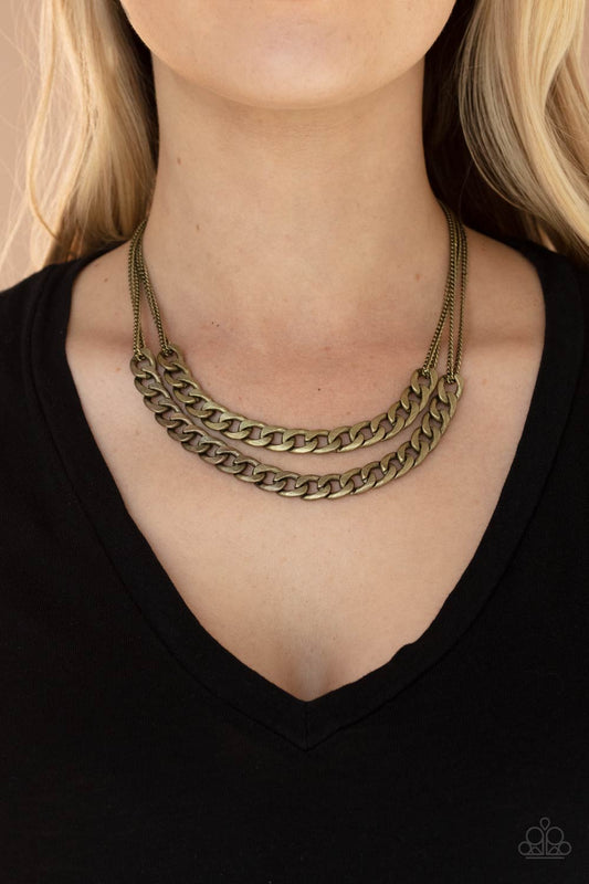 Urban Culture - Brass Necklace two sections of chunky brass curb chain attach to doubled brass chains below the collar, creating an intense industrial centerpiece. Features an adjustable clasp closure.  Sold as one individual necklace. Includes one pair of matching earrings.  Paparazzi Jewelry is lead and nickel free so it's perfect for sensitive skin too!!