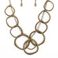 Dizzy With Desire - Brass Circle Link Aurum Rhinestone Necklaces oversized asymmetrical brass rings swing from the bottom of a rustic brass chain. Encrusted in aurum rhinestones, matching brass rings trickle between the dizzying fringe, adding a sparkly smolder to the edgy display. Features an adjustable clasp closure.  Sold as one individual necklace. Includes one pair of matching earrings.  Paparazzi Jewelry is lead and nickel free so it's perfect for sensitive skin too!