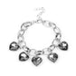 Candy Heart Charmer - Silver Bracelets a smoky heart-shaped gems are encased in sleek silver frames that swing from an oversized silver chain, creating a sparkly fringe around the wrist. Features an adjustable clasp closure.  Sold as one individual bracelet.  Paparazzi Jewelry is lead and nickel free so it's perfect for sensitive skin too!