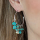 Gorgeously Grounding - Blue Hoop Earrings clusters of turquoise pebbles swing from the bottom of a dainty silver hoop, creating an earthy fringe. A faceted silver and white stone bead swings from the center, adding an ethereal edge. Earring attaches to a standard post fitting. Hoop measures approximately 1 1/4" in diameter.  Sold as one pair of hoop earrings.  Paparazzi Jewelry is lead and nickel free so it's perfect for sensitive skin too!