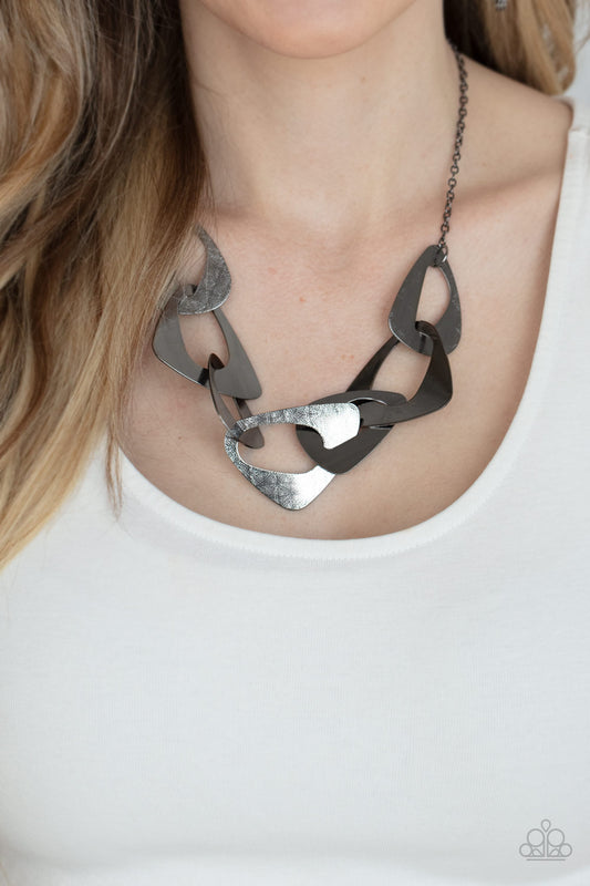 Guide To The Galaxy - Black Triangular Cutout Necklaces large triangular cutouts stamped in a lightly dotted texture link below the collar forming a dramatic display of gunmetal slices. Features an adjustable clasp closure.