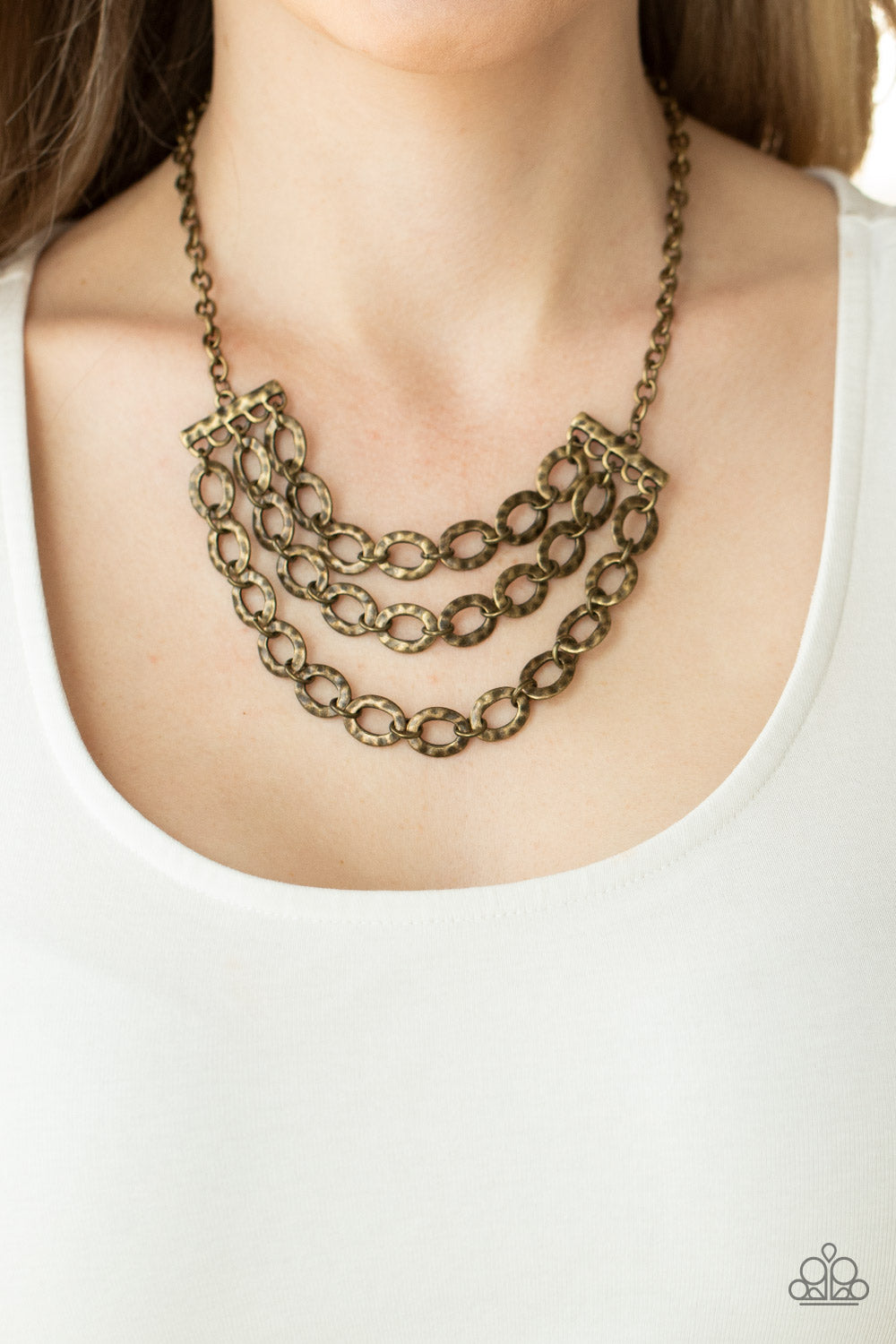 Repeat After Me - Brass Necklaces three rows of antiqued brass chains with oversized hammered oval links attach to brass bars for an edgy display below the collar. Features an adjustable clasp closure.  Sold as one individual necklace. Includes one pair of matching earrings.  Paparazzi Jewelry is lead and nickel free so it's perfect for sensitive skin too!