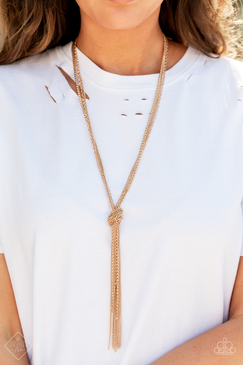 Knot All There - Gold Tassel Necklaces strands of long glistening gold chains in round, delicate, and classic styles are pulled together in a sassy knot creating a show-stopping fringe tassel and a flirty finish. Features an adjustable clasp closure.  Sold as one individual necklace. Includes one pair of matching earrings.  Paparazzi Jewelry is lead and nickel free so it's perfect for sensitive skin too!
