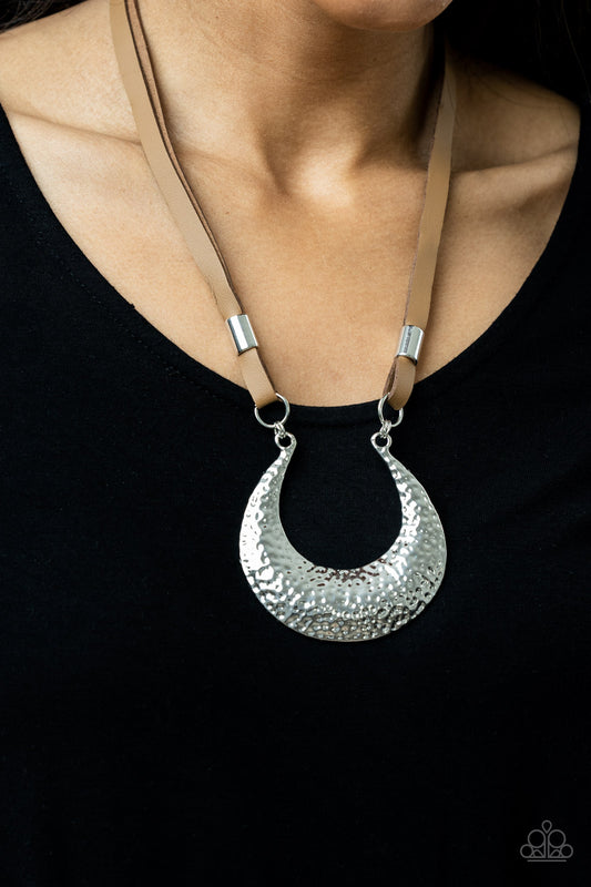 Paparazzi Majorly Moonstruck - Brown Necklaces infused with shiny silver beads, strips of brown leather link to an oversized half moon pendant that is hammered in a blinding silver finish, creating a rustic statement piece below the collar. Features an adjustable clasp closure.  Sold as one individual necklace. Includes one pair of matching earrings.