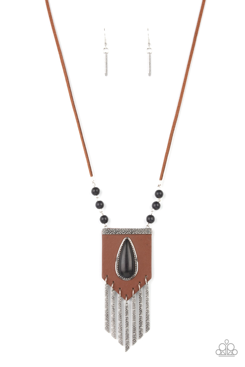 Enchantingly Tribal - Black Leather Necklaces - Paparazzi Accessories bold black teardrop stone encased in an antiqued silver frame is centered on a brown leather insignia-like pendant. Decorated with a silver plate embossed in geometric designs and a tinkling fringe of embossed silver plates suspended from the bottom, the pendant sways from lengthened leather cords accented with black stone beads for an enchantingly timeless finish. Features an adjustable clasp closure.  Sold as one individual necklace.