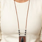 Enchantingly Tribal - Black Leather Necklaces - Paparazzi Accessories bold black teardrop stone encased in an antiqued silver frame is centered on a brown leather insignia-like pendant. Decorated with a silver plate embossed in geometric designs and a tinkling fringe of embossed silver plates suspended from the bottom, the pendant sways from lengthened leather cords accented with black stone beads for an enchantingly timeless finish. Features an adjustable clasp closure.  Sold as one individual necklace.