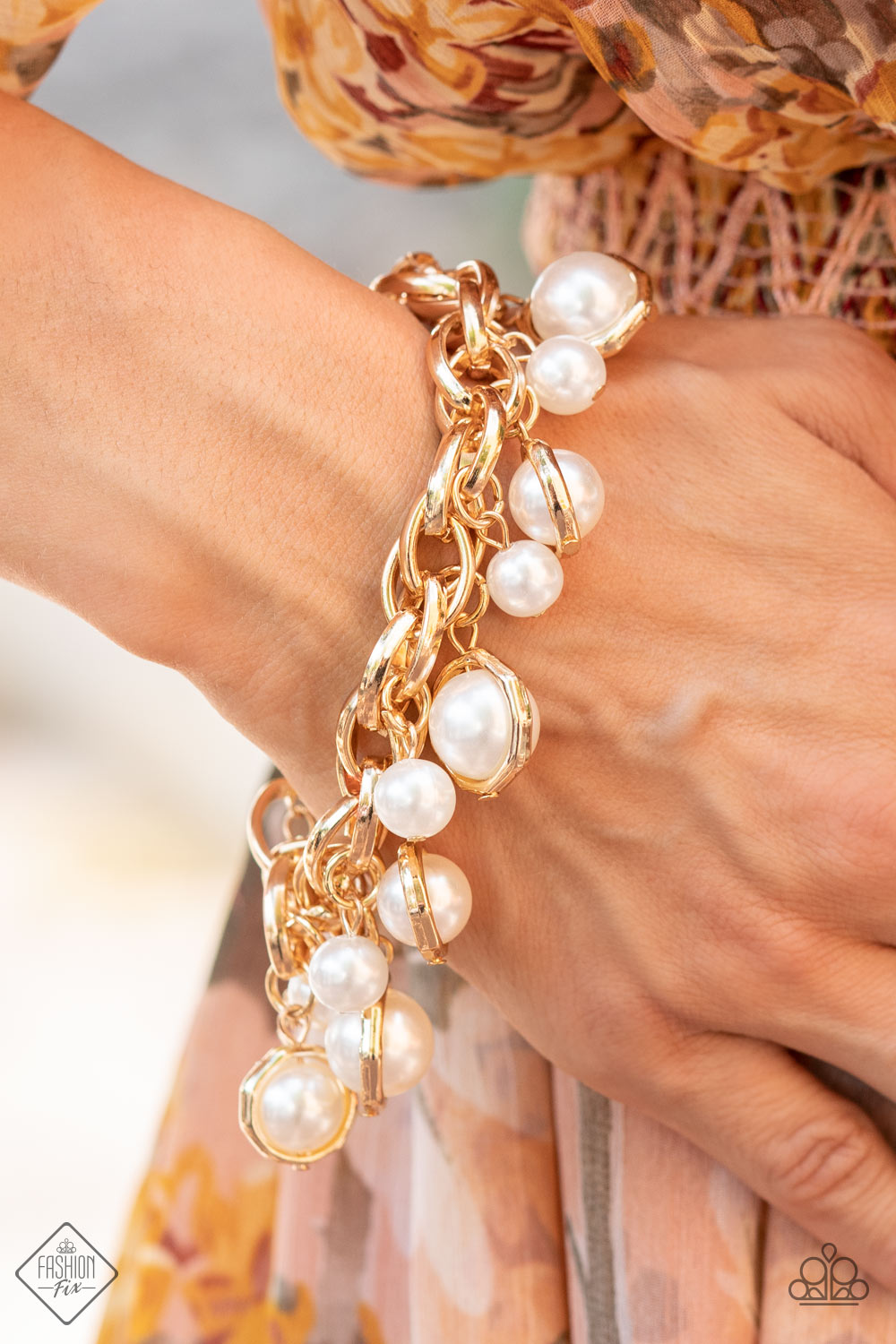 Orbiting Opulence - Gold Pearl Bracelets classic white pearls and solitaire pearls that are threaded along a rod inside imperfect gold rings swing from a chunky double-linked gold chain around the wrist, creating a dramatic fringe. Features an adjustable clasp closure.  Sold as one individual bracelet.