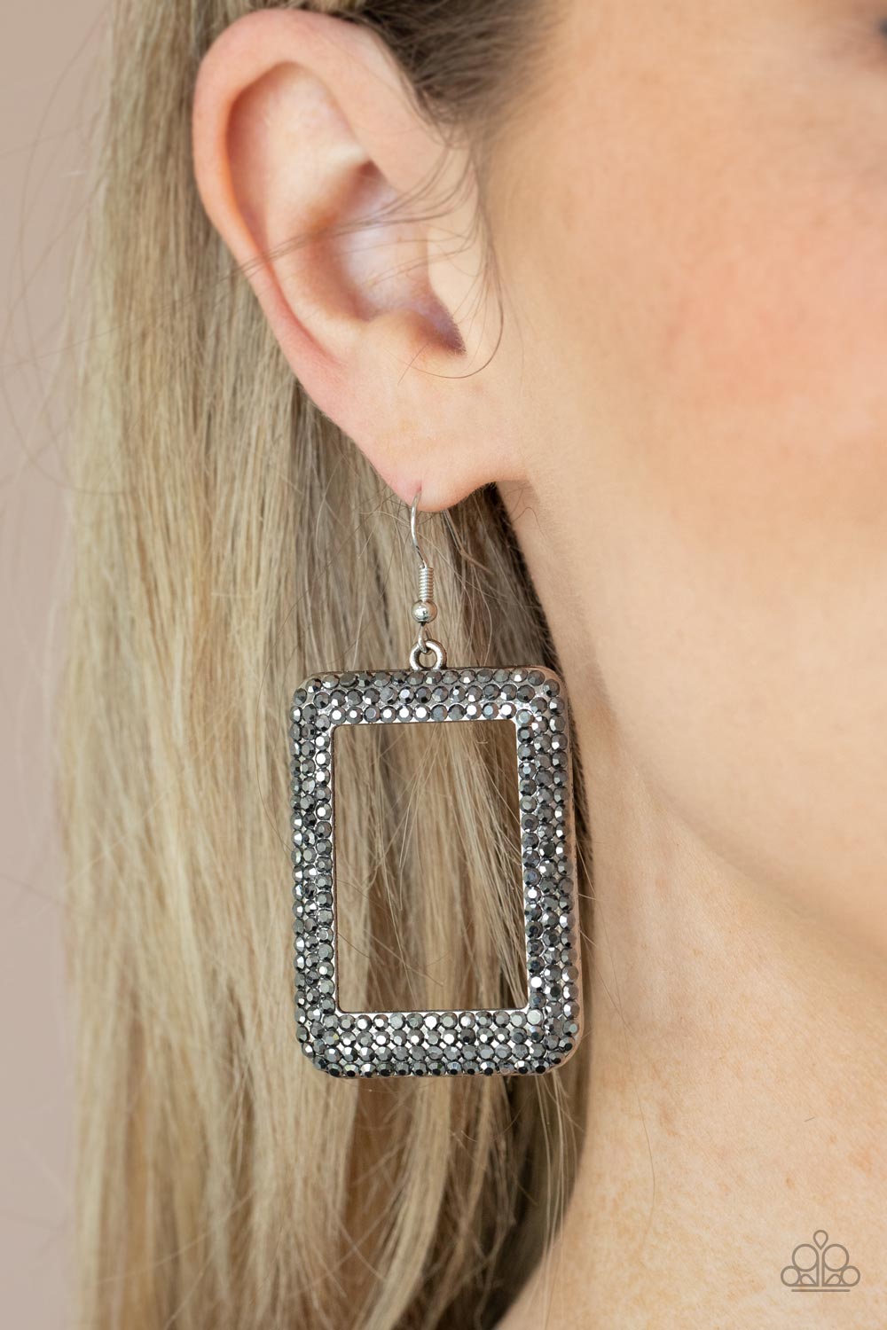 Paparazzi Accessories World FRAME-OUS - Silver Fishhook Earrings bordered in rows of smoky hematite rhinestones, an oversized silver rectangular frame swings from the ear for a fashionable finish. Earring attaches to a standard fishhook fitting.