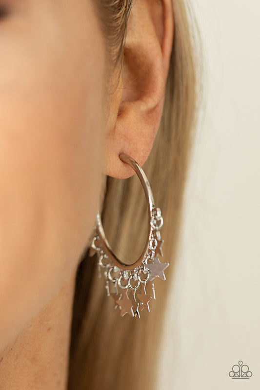 Paparazzi Happy Independence Day - Silver Star Earrings a shiny collection of silver star charms trickles from the bottom of a classic silver hoop, creating a stellar fringe. Earring attaches to a standard post fitting. Hoop measures approximately 1 1/4" in diameter.  Sold as one pair of hoop earrings.
