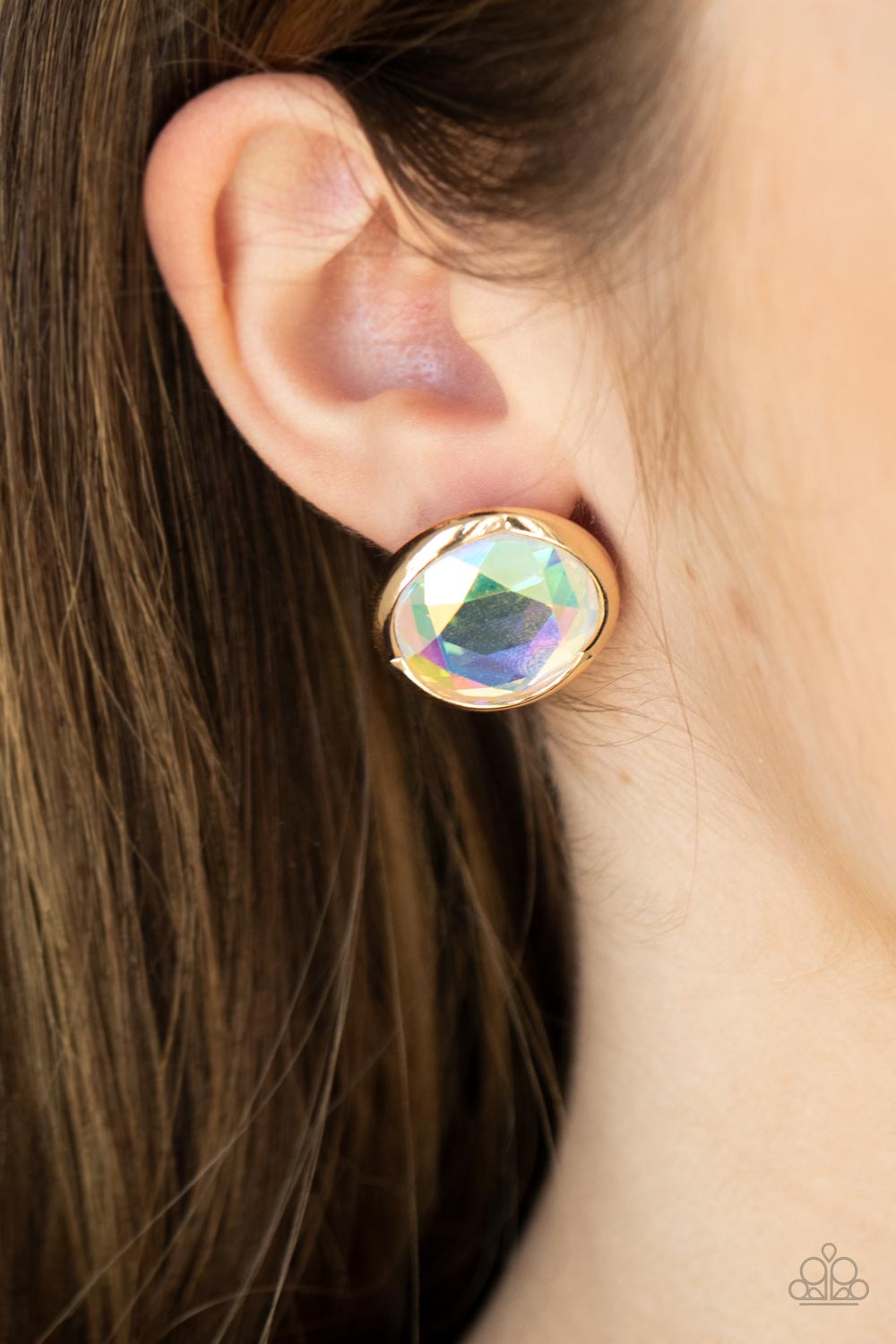 Double-Take Twinkle - Gold Iridescent Gem Post Earrings featuring a flashy faceted finish, an oversized iridescent gem is pressed into a sleek gold fitting for a dramatic pop of dazzle. Earring attaches to a standard post fitting.  Sold as one pair of post earrings.
