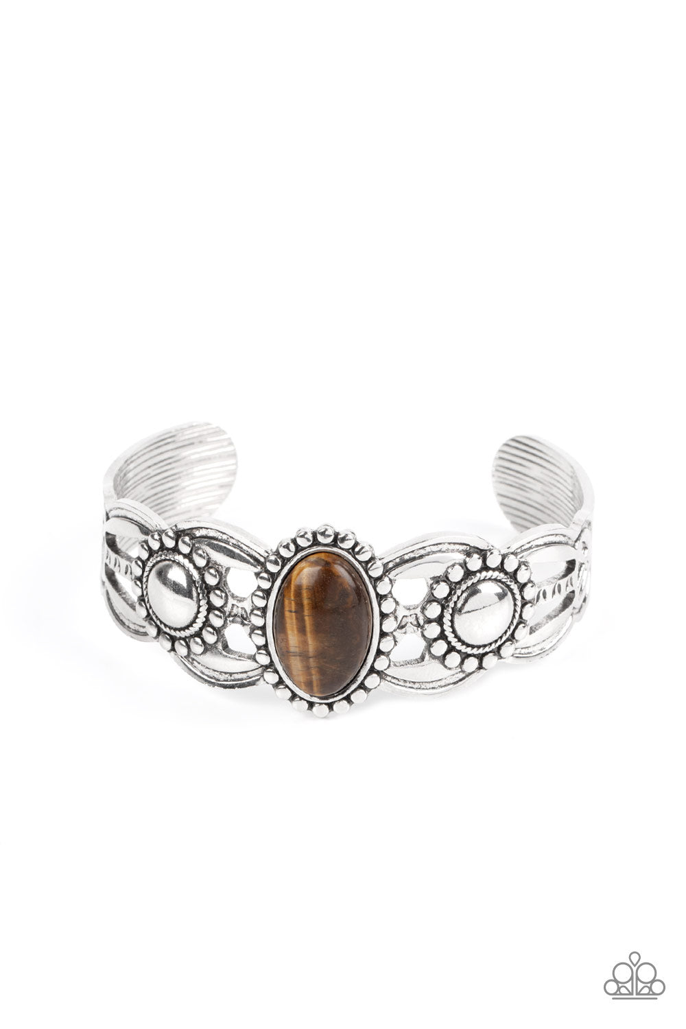 Paparazzi Accessories Solar Solstice - Brown Cuff Bracelets an oval Tiger's eye stone is pressed into the center of a studded silver frame atop an airy silver cuff embellished in studded sun-like frames for an earthy pop of seasonal color around the wrist.