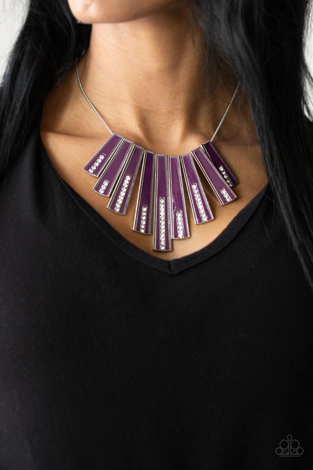 FAN-TASTICALLY Deco - Purple Flared Necklaces encased in daintily dotted silver frames, a row of flared silver bars painted in a glossy purple, fans out across the collar. A column of sparkling white rhinestones rises from the bottom of each frame, creating a dramatically deco finish as they sway from a round silver chain. Features an adjustable clasp closure.
