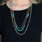 Artisanal Abundance - Gold Turquoise Layered Necklaces infused with sections of refreshing turquoise stones, a trio of mismatched gold chains layer down the chest for a dash of earthy refinement. Features an adjustable clasp closure.  Sold as one individual necklace. Includes one pair of matching earrings.