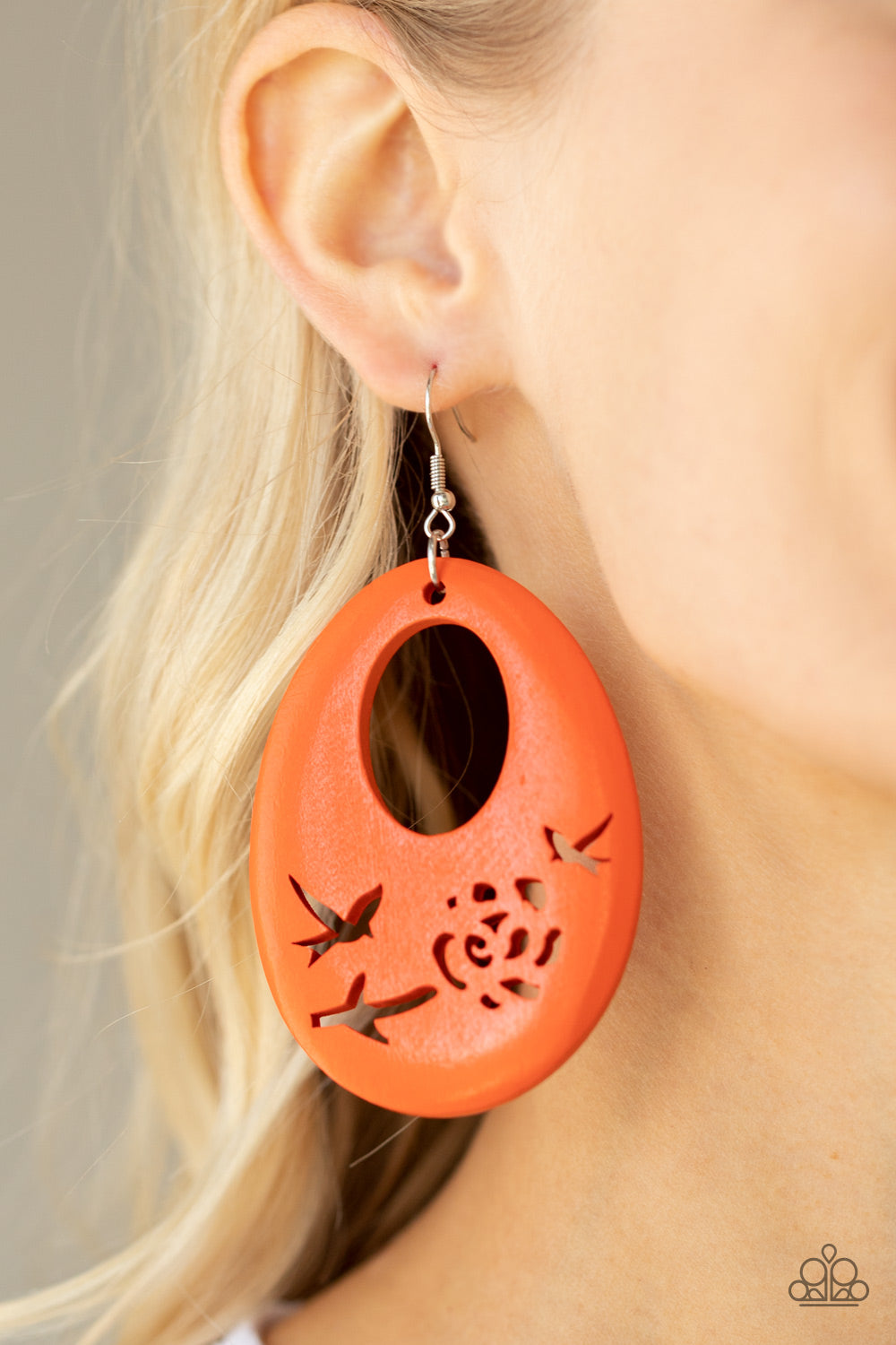 Home TWEET Home - Orange Wood Earrings the bottom of a vivacious orange wooden teardrop frame features bird and floral cutouts, creating a whimsical centerpiece. Earring attaches to a standard fishhook fitting.  Sold as one pair of earrings.