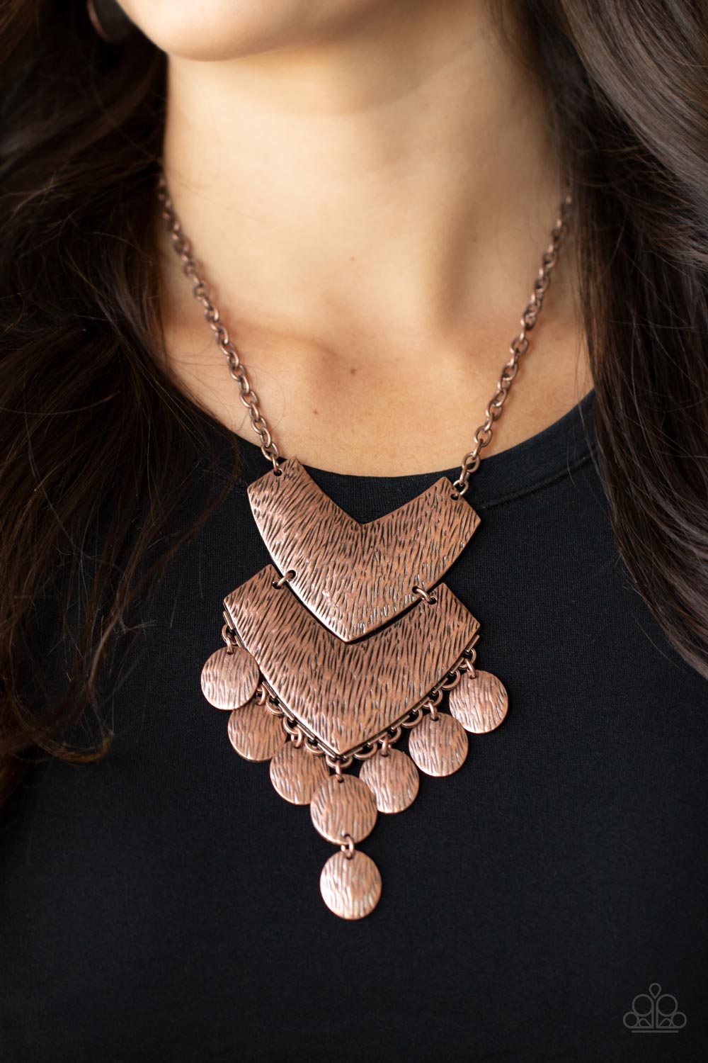 Keys to the Animal Kingdom - Copper Necklaces etched in rustic copper textures, a pair oversized chevron-like copper frames delicately link into a wild statement piece. Matching textured copper discs swing from the bottom of the stacked display, adding noisemaking movement to the rambunctious pendant. Features an adjustable clasp closure.  Sold as one individual necklace. Includes one pair of matching earrings.
