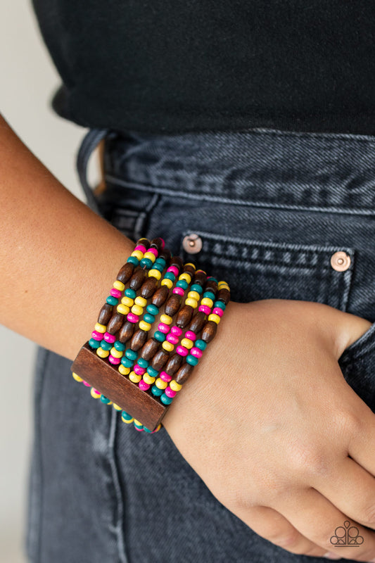 Paparazzi Accessories Tropical Nirvana - Multi Wood Bracelets held together with brown wooden rectangular frames, mismatched rows of oval brown and round multicolored wooden beads are threaded along stretchy bands around the wrist for a whimsically layered look.  Sold as one individual bracelet.