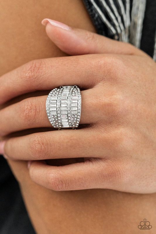 Red Carpet Redux - White Rhinestone LOP Rings the front of a silver oval frame is encrusted in stacked rows of emerald and round cut white rhinestones, coalescing into a blinding centerpiece atop the finger. Features a stretchy band for a flexible fit.  Sold as one individual ring.
