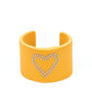 Rodeo Romance - Yellow Leather Heart Cuff Bracelets the center of a yellow leather cuff is studded in a charming heart pattern, creating a rustically romantic look around the wrist.  Sold as one individual bracelet.