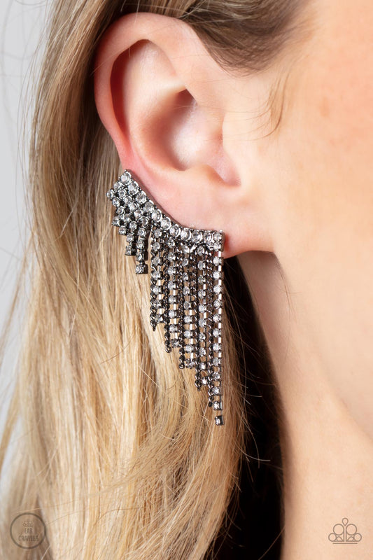 Paparazzi Accessories - Thunderstruck Sparkle - Black Ear Crawlers Earrings a tapered fringe of dainty gunmetal chains and glittery strands of white rhinestones cascades from the edge of a curving white rhinestone encrusted frame, creating an edgy centerpiece. Features a clip-on fitting at the top for a secure fit.  Sold as one pair of ear crawlers.