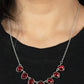 Material Girl Glamour - Red Necklaces encased in sleek silver fittings, elegant cut fiery red rhinestones delicately connect below the collar. An oversized red rhinestone adorns to the middle of the glittery strand, creating a sparkly centerpiece. Features an adjustable clasp closure.  Sold as one individual necklace. Includes one pair of matching earrings.  Paparazzi Jewelry is lead and nickel free so it's perfect for sensitive skin too!